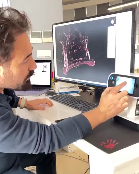Designer examines a scanned ornamental relief on screen