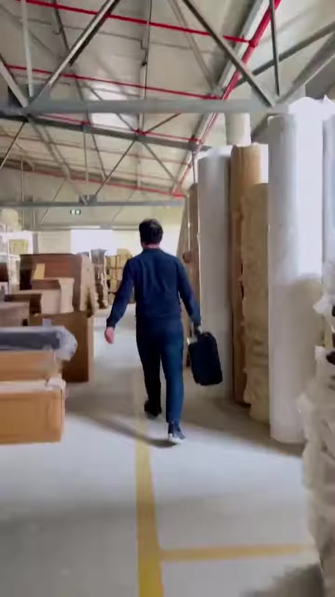 Production warehouse shelves hold stacked decorative molding elements