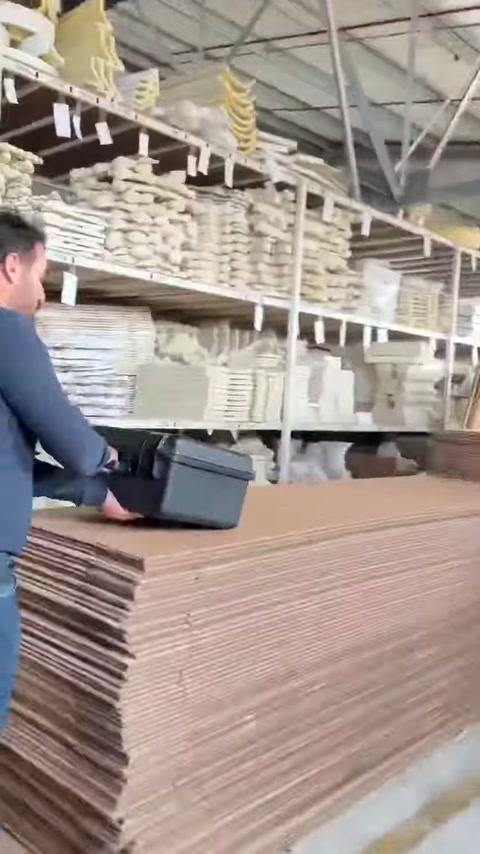 Workers move through shelves filled with architectural ornament pieces