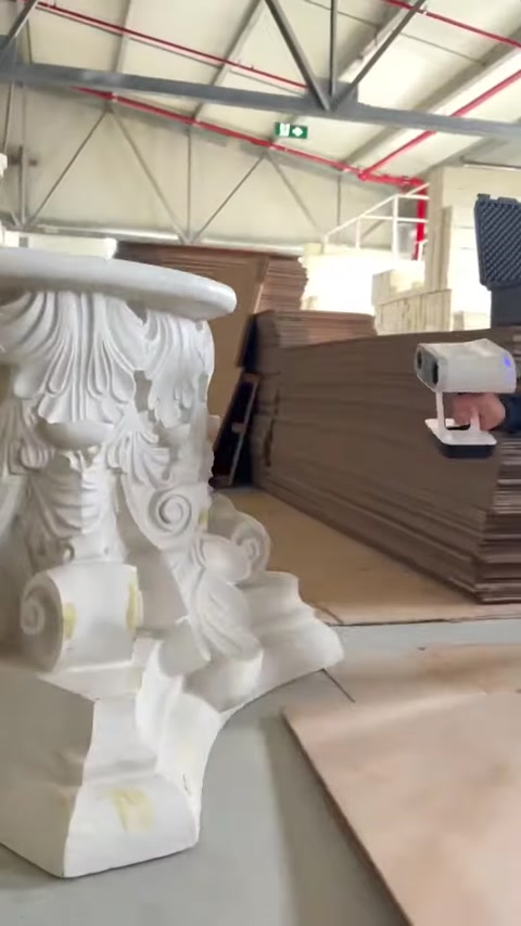 3D scanner records the surface of an ornate architectural piece
