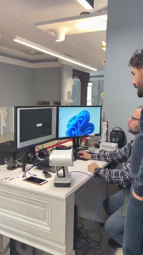 Design team reviews digital models at a workstation