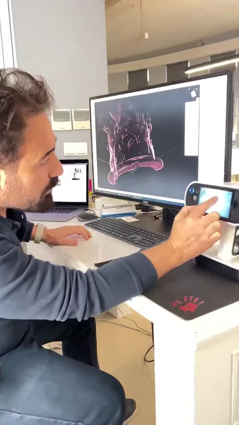 Designer examines a scanned ornamental relief on screen