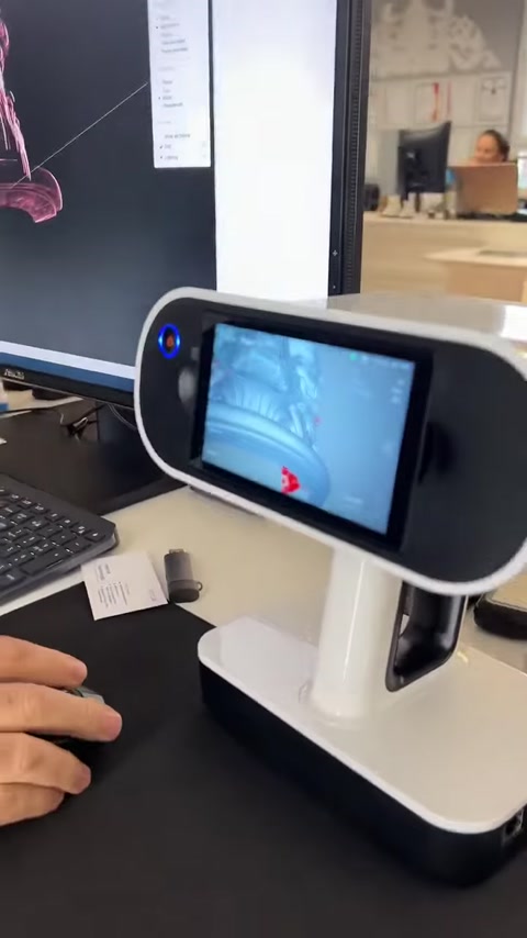 3D scanning equipment sits beside digital architectural modeling work