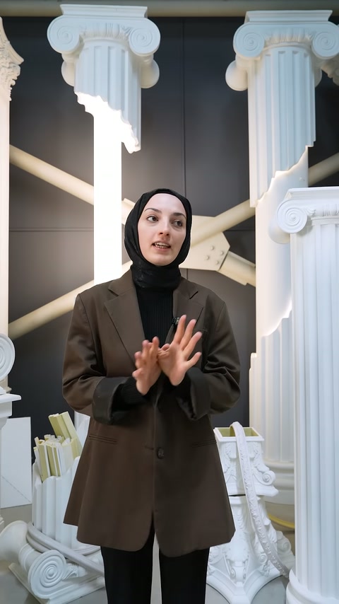 Showroom presenter in brown jacket greets viewers and starts the video