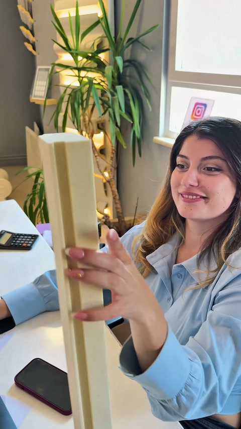 Worker pointing to the channel section of a vertically held profile