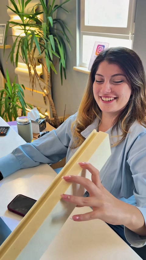 Worker moving a long profile section to horizontal position with both hands