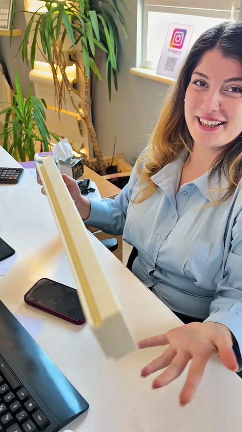 Worker holding profile sample vertically to display the channel line