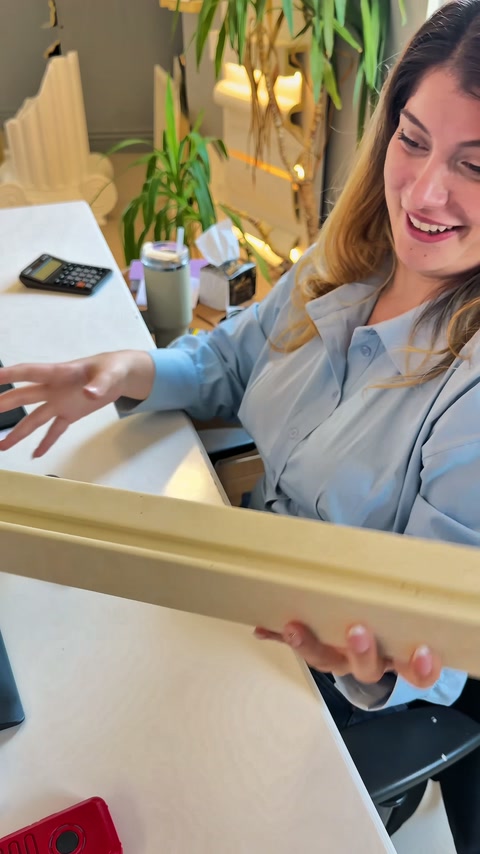 Worker supporting the flat surface of the profile on the palm to demonstrate