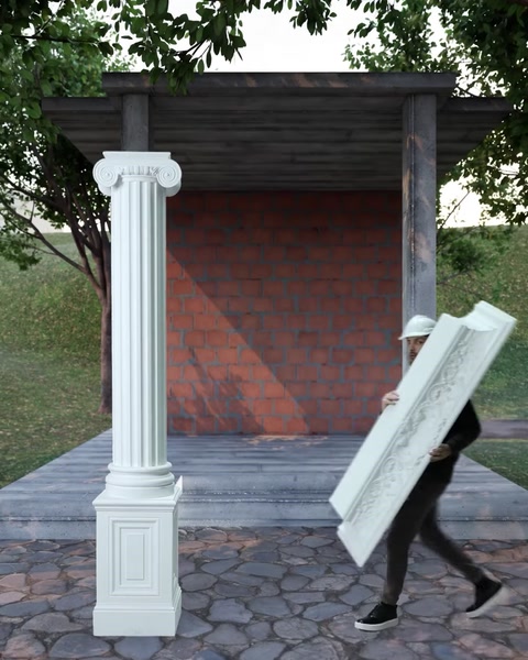 L'installatore trasporta il pezzo di cornice decorativa verso la colonna completata.