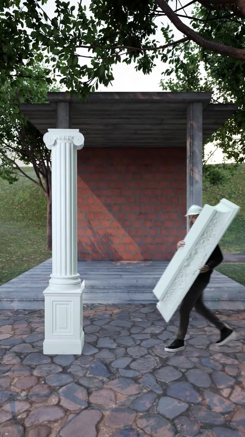 L'installatore trasporta il pezzo di cornice decorativa verso la colonna completata.