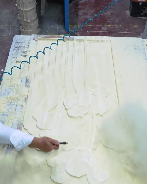 Worker marking relief pattern on CNC with pencil