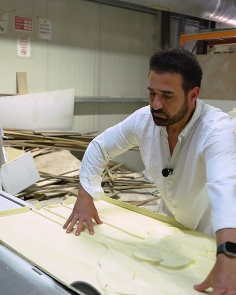 Worker examining polyurethane sheet material in workshop