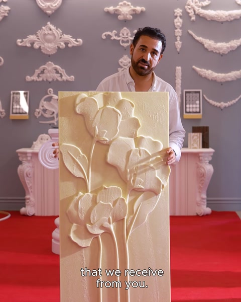 Manufacturer lifting floral relief panel with both hands
