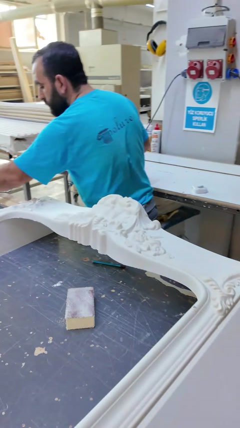 Decorative mantel surround rests on a workbench during initial assembly.