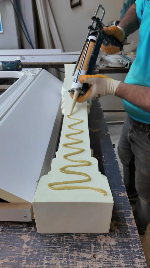 Assembly adhesive is applied along a fireplace component before joining.