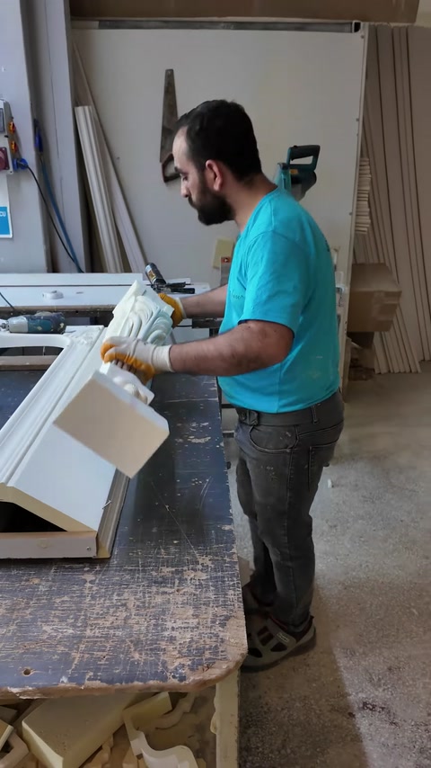 Craftsman aligns a fluted pilaster beneath the decorative mantel.
