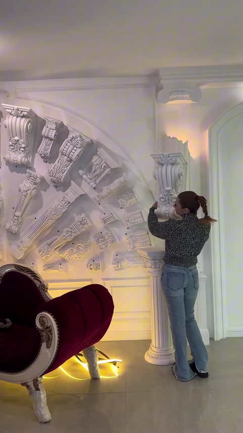 Various column capitals and decorative elements displayed on the wall