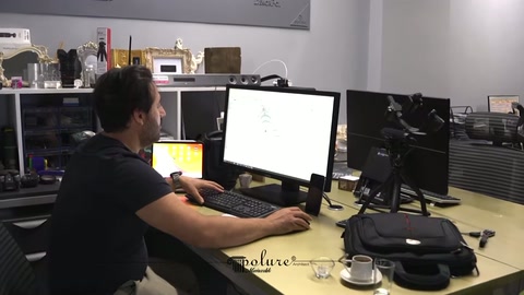 Designer carefully examines a window surround draft on the computer screen in the office