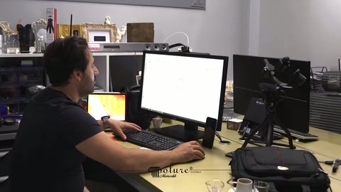 Designer edits the digital drawing of an arch piece at the work desk