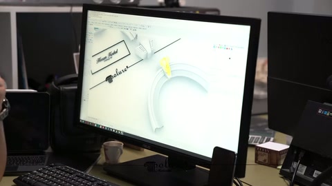 Colorful arch design with curved form is examined on the computer monitor