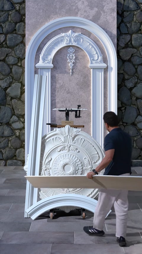 Man carrying plaster column piece toward wall design mockup