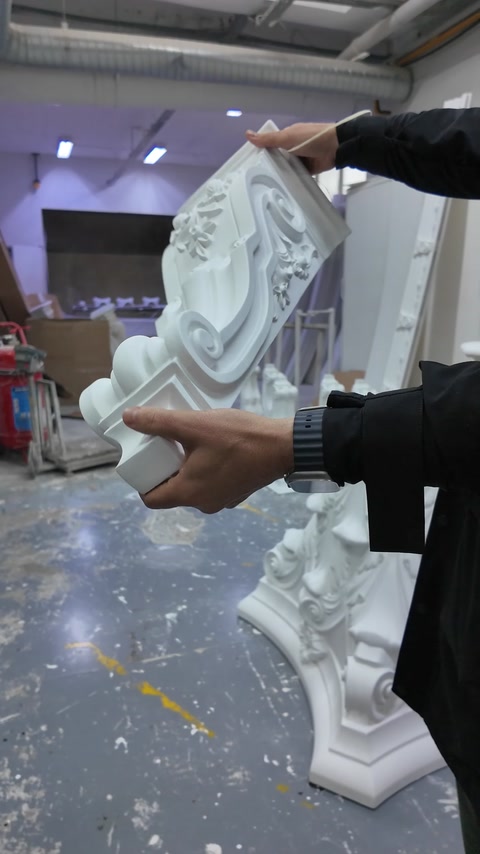 The spiral volute and leaf carvings on the column capital are shown in close-up