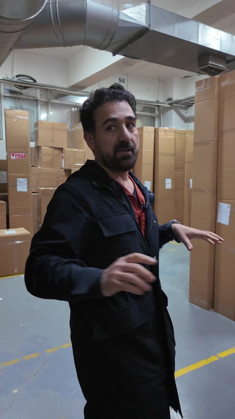 Large parcels prepared for shipment are arranged in a warehouse corridor