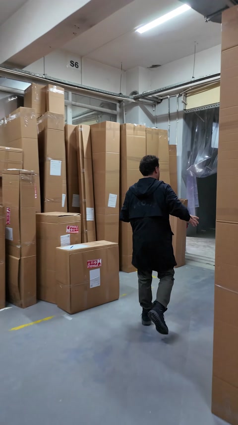 Labeled long parcels are waiting in an area near the loading zone