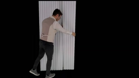 Moment of application as a vertical slatted panel is positioned on the wall surface