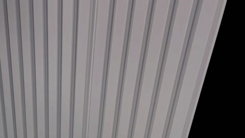 Close-up surface detail of a wave-textured polyurethane wall panel