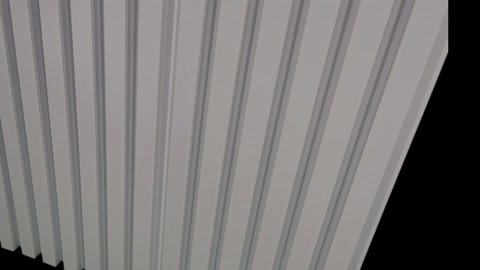 Angled view of white wall panel with raised ribs is examined.