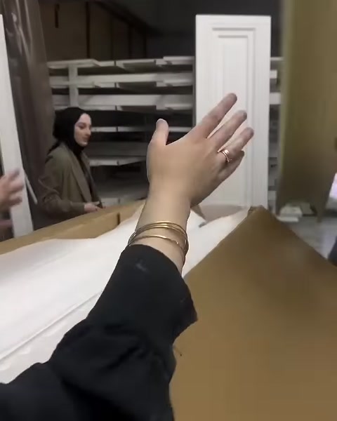 A decorative profile with a rectangular frame detail is examined by hand
