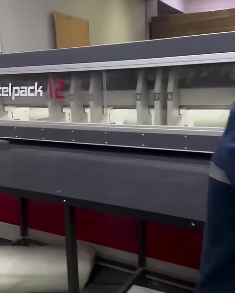 Long decorative profiles are lined up in the working section of a production machine