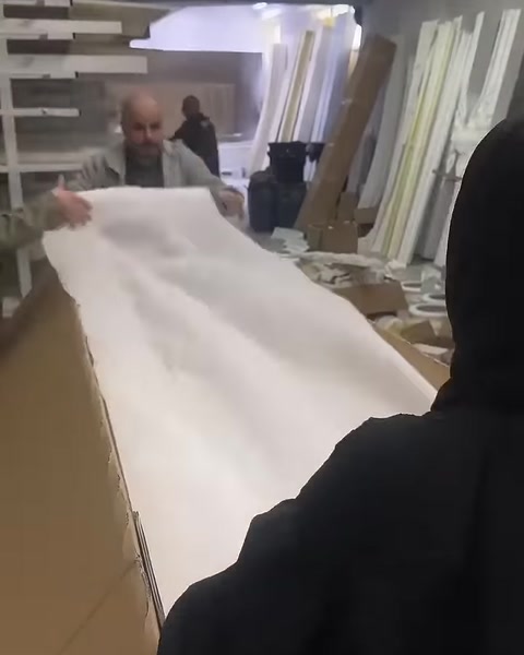 Decorative profiles in the box are covered with a white protective sheet