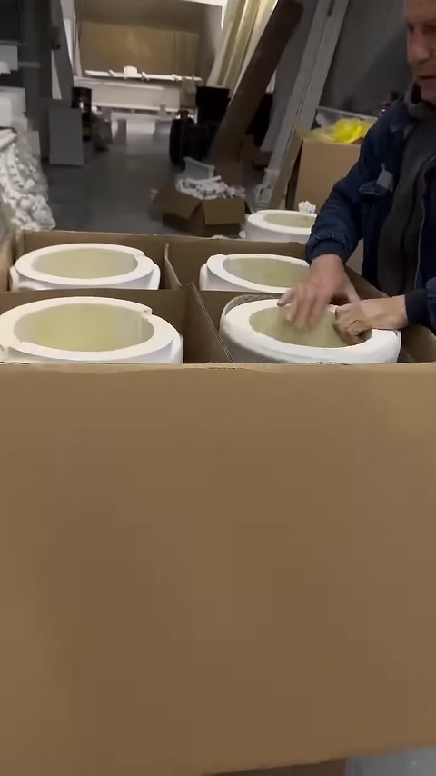 Circular column parts are neatly placed in a shipping box