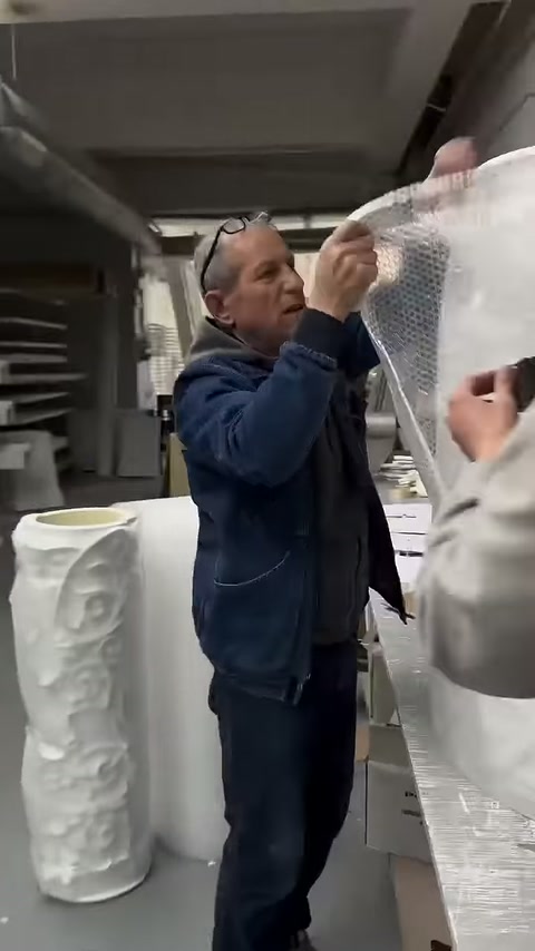 Upper section of column piece being enclosed with protective packaging