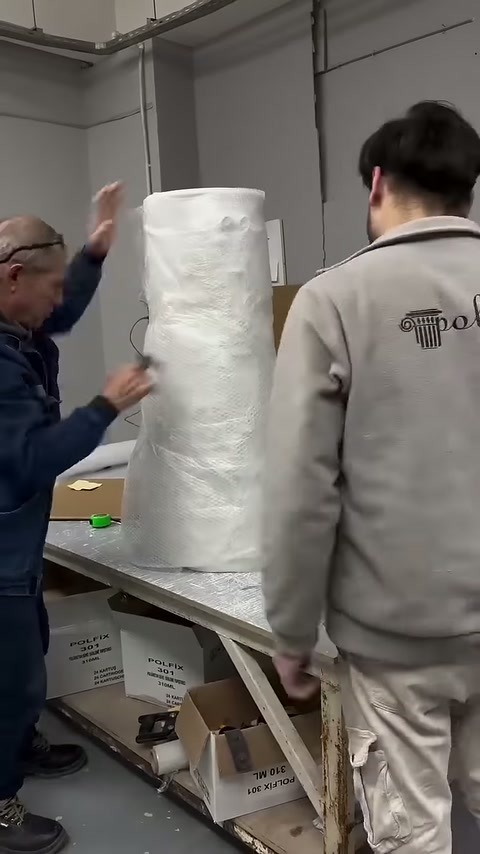 Upper edge of protective cover being adjusted on the decorative column