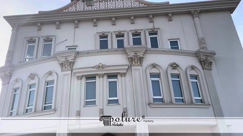 Classical architectural façade details across the floors of a white building