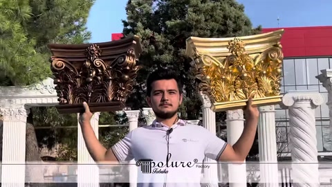 Dark and gold-coloured column capitals displayed together