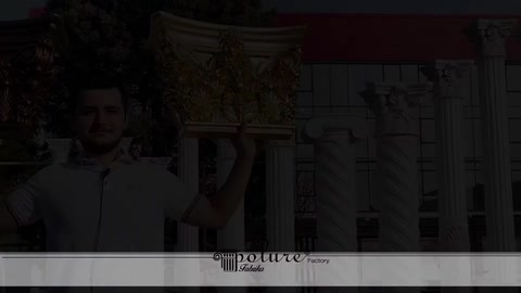 Column capital silhouette and a staff member during a dark transition