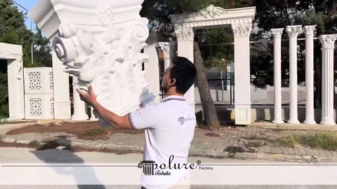Curled decorative elements of a Corinthian-style column capital shown in hand