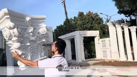 Staff member rotating the white capital to present its embossed surface