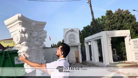 Wide Corinthian capital lifted with both hands in an outdoor area