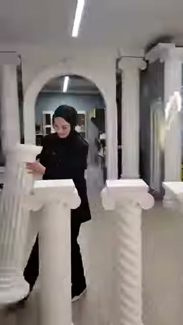 L'addetto si posiziona dietro due cornici quadrate dalle linee semplici.