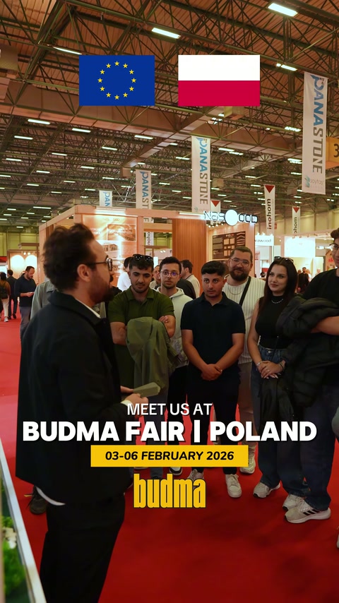 Fuar koridorunda standın önünde toplanan katılımcılar sohbet ediyor