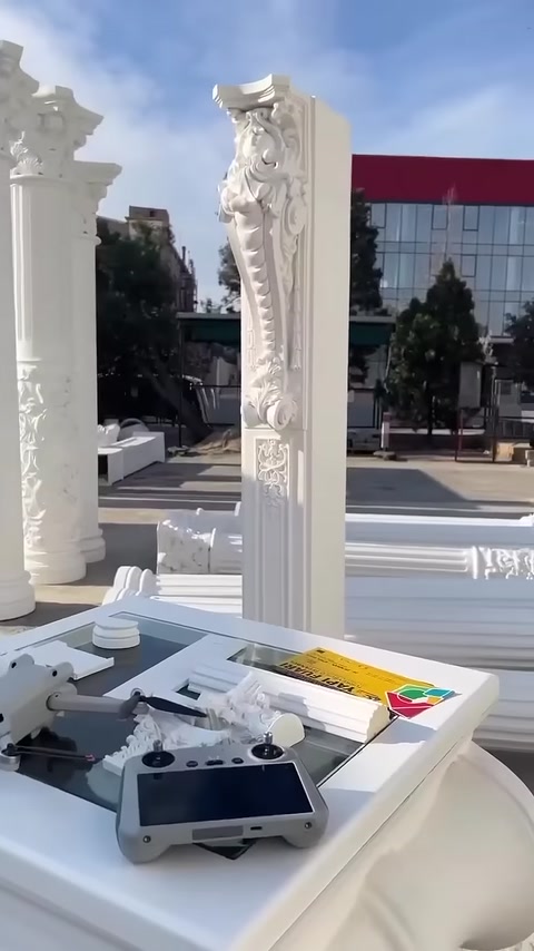 Ornate column and capital models are displayed in the production area