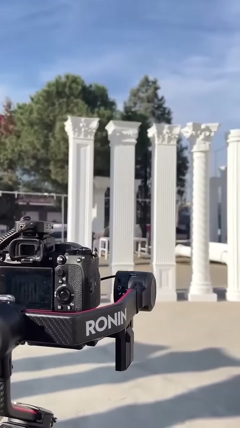 The filming camera is directed at the fluted columns displayed in the open area