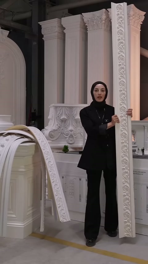 Video showcases a decorative polyurethane cornice with embossed design displayed vertically in a showroom area