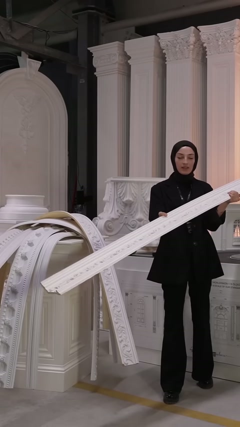 Decorated cornice is displayed diagonally in front of decorative columns