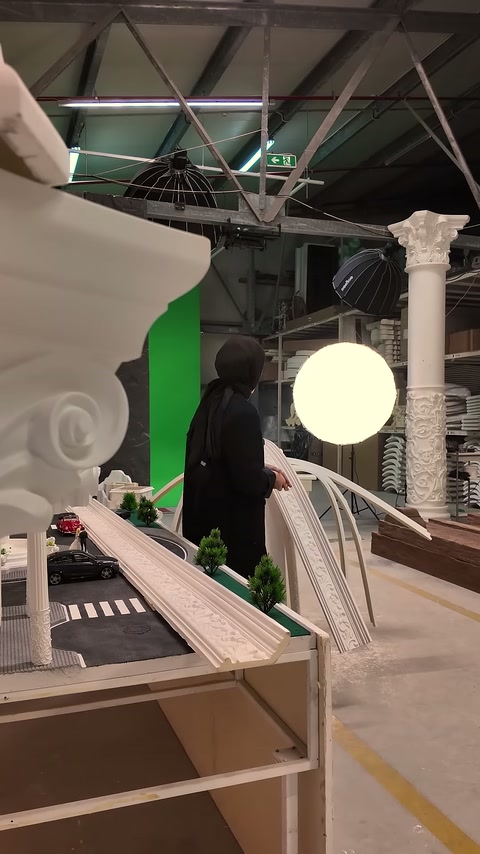 Long patterned profile is laid horizontally on a stand in front of the applicator